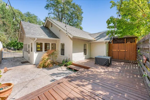 a front view of a house with a yard and potted plants