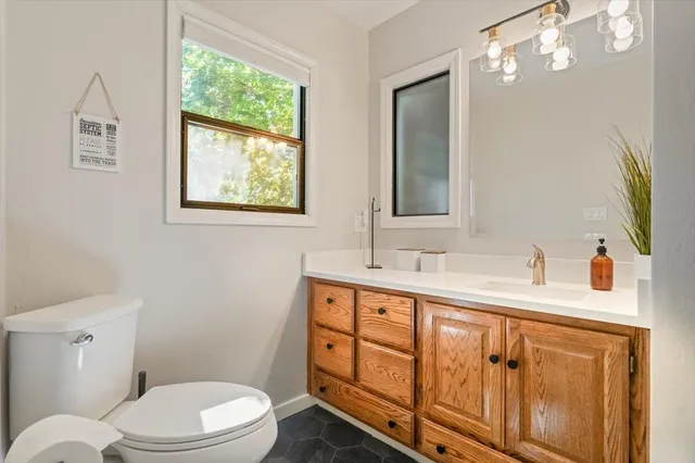 a bathroom with a toilet sink and mirror