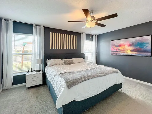 a bedroom with a bed and a large window