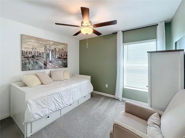 a spacious bedroom with a bed and a chandelier