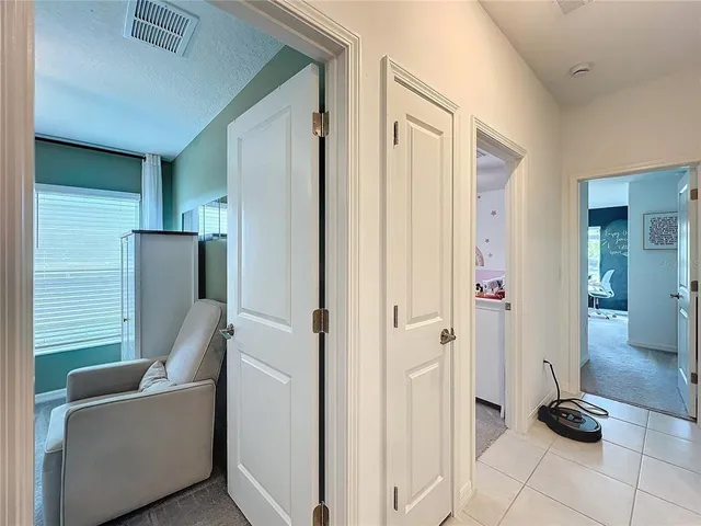 a view of a livingroom with furniture and a hallway