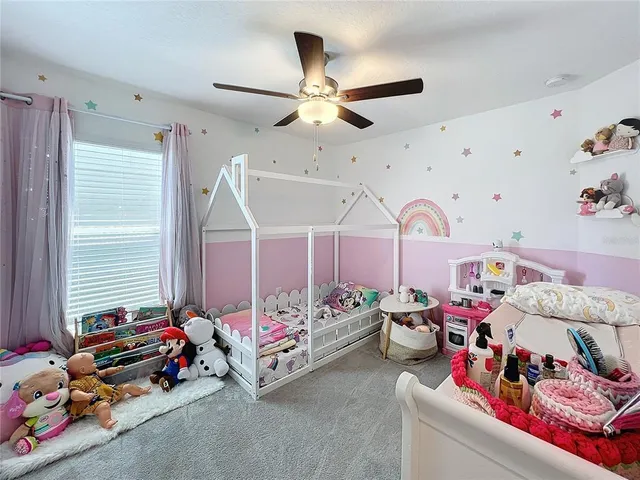 a bedroom with lots of furniture and a chandelier