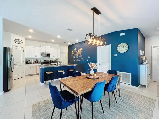 a large kitchen with a table and chairs
