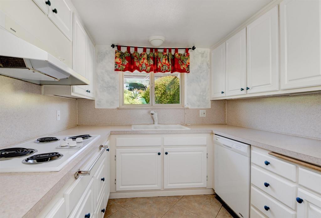 640 West Solana Circle, Unit 1 Solana Beach, CA 92075 - Photo 15 of 42 a kitchen with granite countertop a sink a stove and cabinets