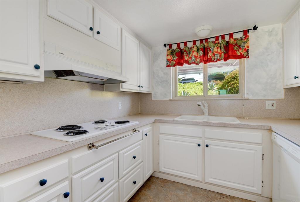 640 West Solana Circle, Unit 1 Solana Beach, CA 92075 - Photo 16 of 42 a kitchen with white cabinets and window
