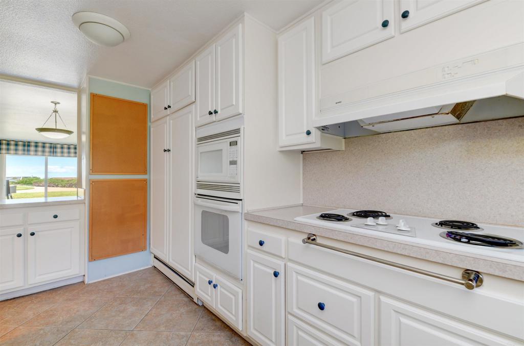 640 West Solana Circle, Unit 1 Solana Beach, CA 92075 - Photo 17 of 42 a kitchen with white cabinets and appliances
