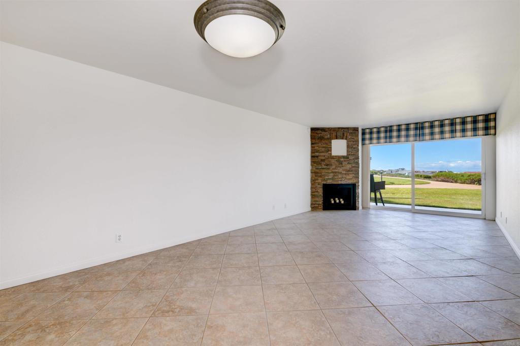 640 West Solana Circle, Unit 1 Solana Beach, CA 92075 - Photo 32 of 42 a view of an empty room with a fireplace and a window