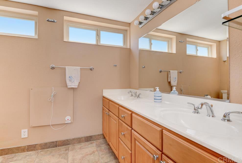 640 West Solana Circle, Unit 1 Solana Beach, CA 92075 - Photo 36 of 42 a bathroom with a sink and a mirror