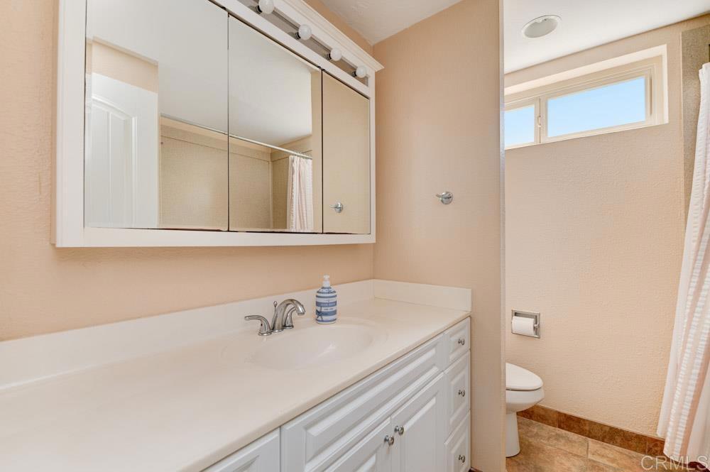 640 West Solana Circle, Unit 1 Solana Beach, CA 92075 - Photo 40 of 42 a bathroom with a sink a toilet and a mirror