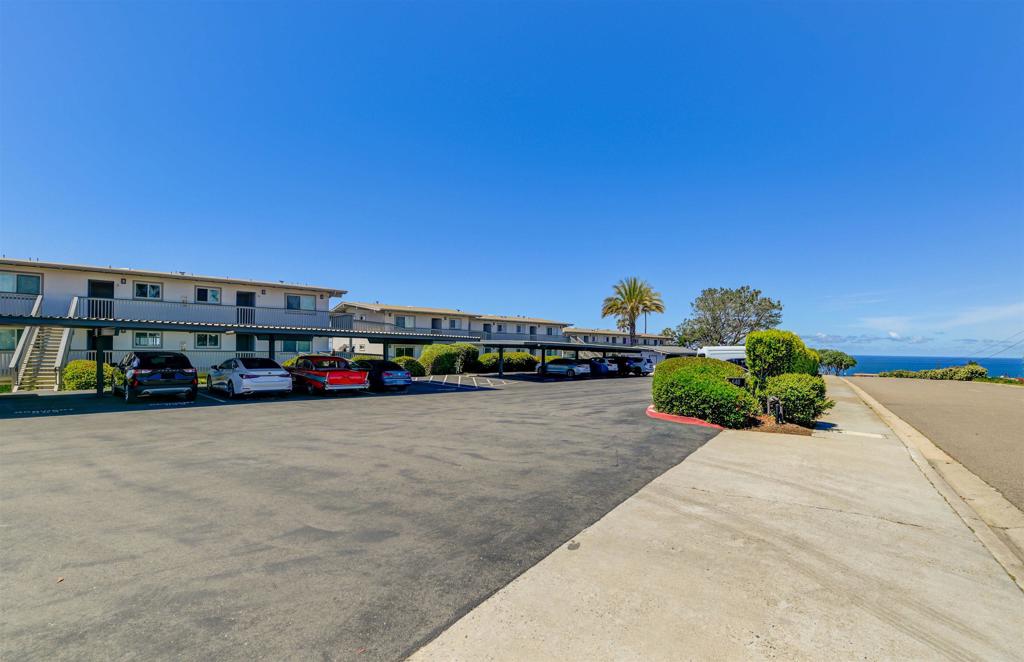 640 West Solana Circle, Unit 1 Solana Beach, CA 92075 - Photo 42 of 42 a car parked in front of a building with trees