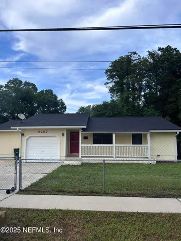 a front view of a house with a garden