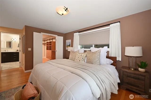 a bedroom with a bed and a lamp on table