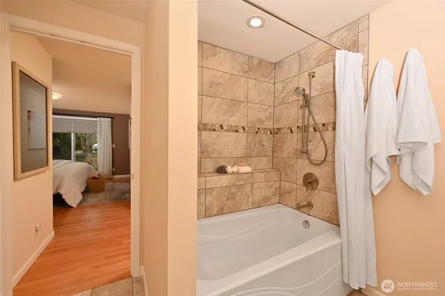 a bathroom with a bathtub and a shower