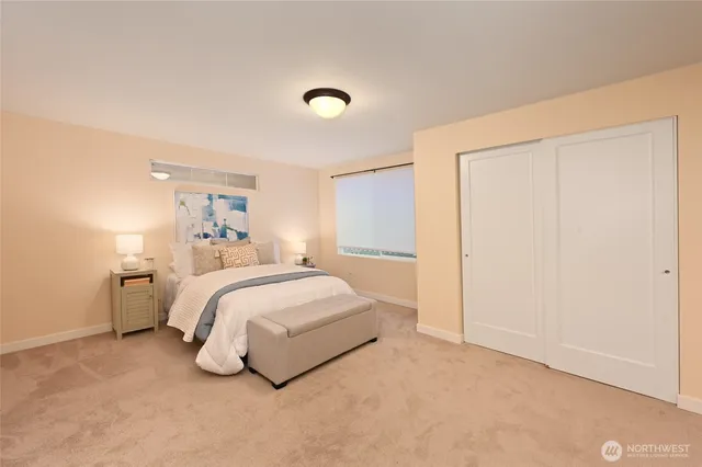 a spacious bedroom with a bed and a closet