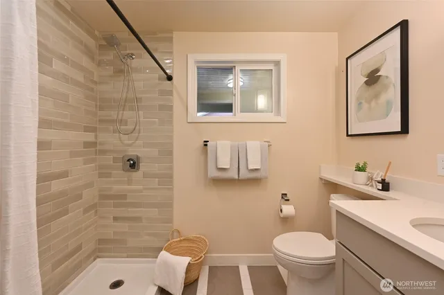 a bathroom with a sink toilet and shower