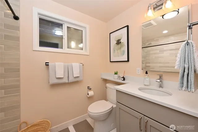 a bathroom with a toilet sink and mirror