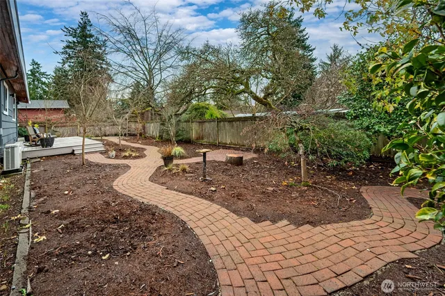 a view of a backyard with table and chairs under an umbrella