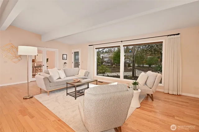a living room with furniture large window and a floor to ceiling window