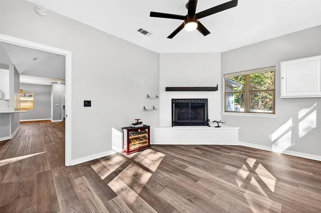 a view of empty room with wooden floor
