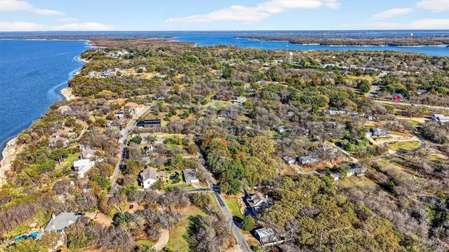 a view of an outdoor space with wooden floor and bench