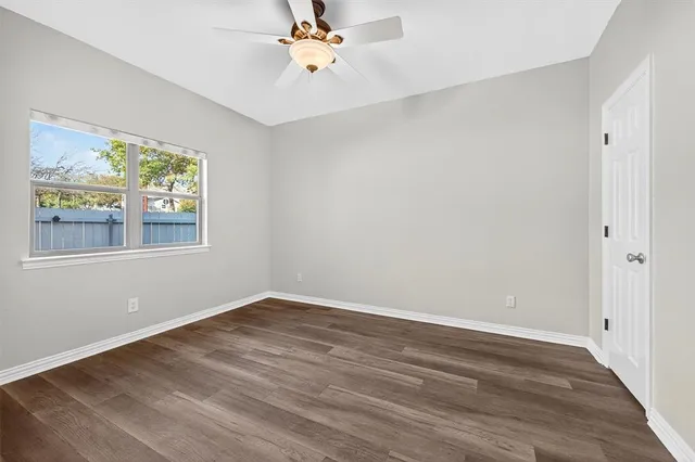 a view of a room with wooden floor and window