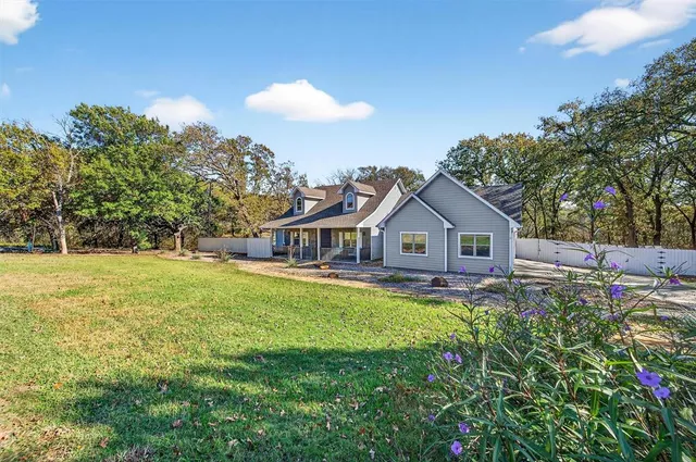 a view of empty room with wooden floor and fireplace