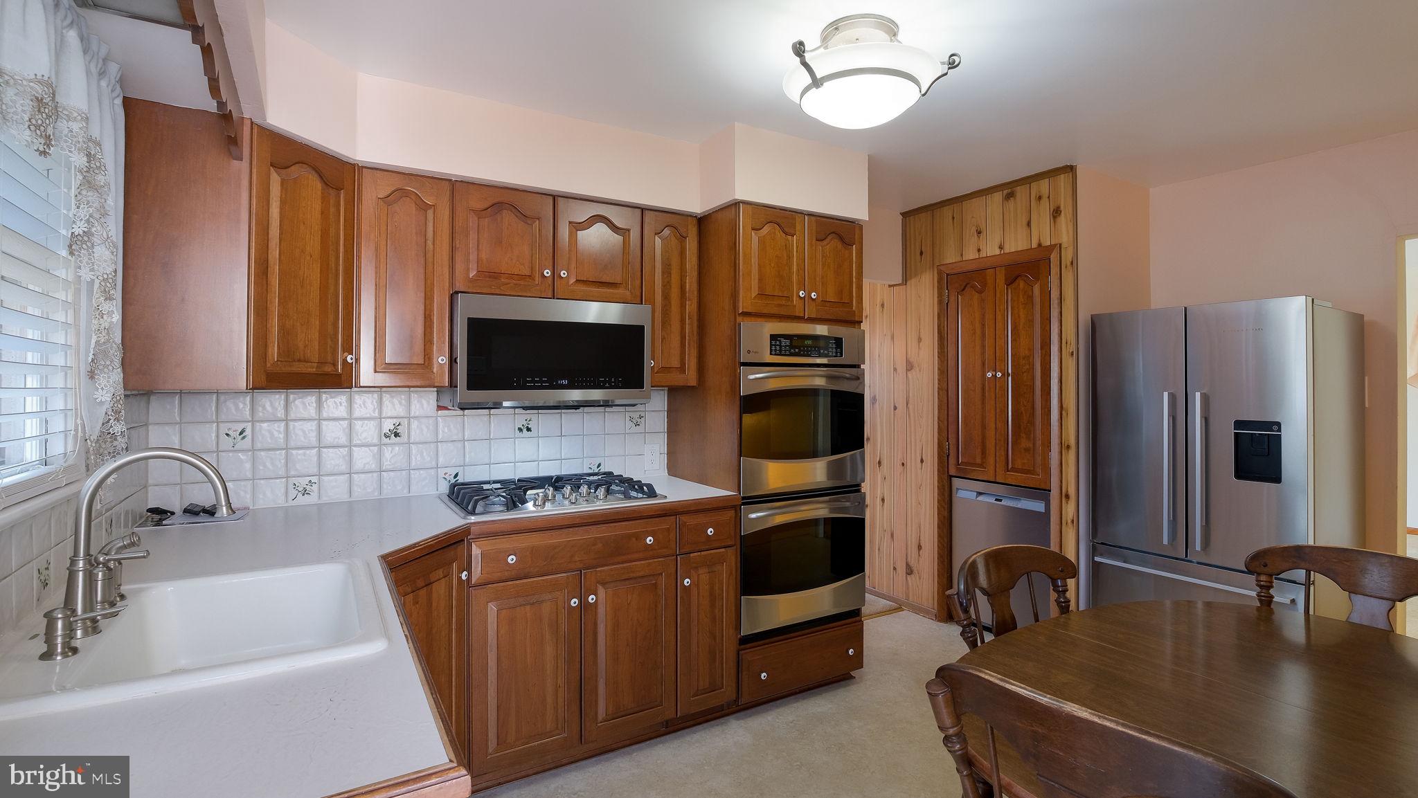2473 Susquehanna Road Abington, PA 19001 - Photo 14 of 46 a kitchen with stainless steel appliances granite countertop a sink refrigerator stove and microwave