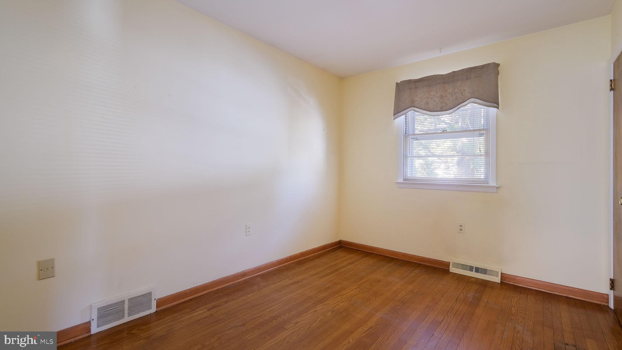 2473 Susquehanna Road Abington, PA 19001 - Photo 23 of 46 a view of an empty room with wooden floor and a window