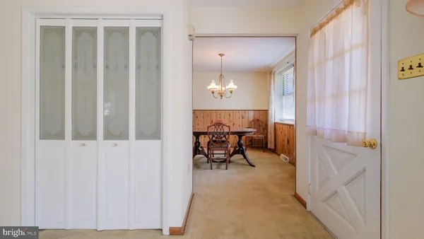 a view of a room with a table and chairs in wooden floor