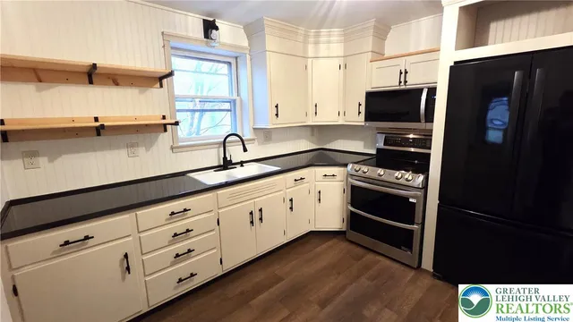 a kitchen with granite countertop cabinets and steel stainless steel appliances