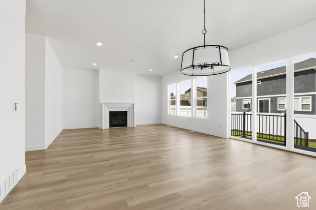 79 South Crimson Way West, Unit 307 Mapleton, UT 84664 - Photo 16 of 42 Expansive living area with light wood-finish flooring, a white mantel fireplace, and recessed ceiling lighting