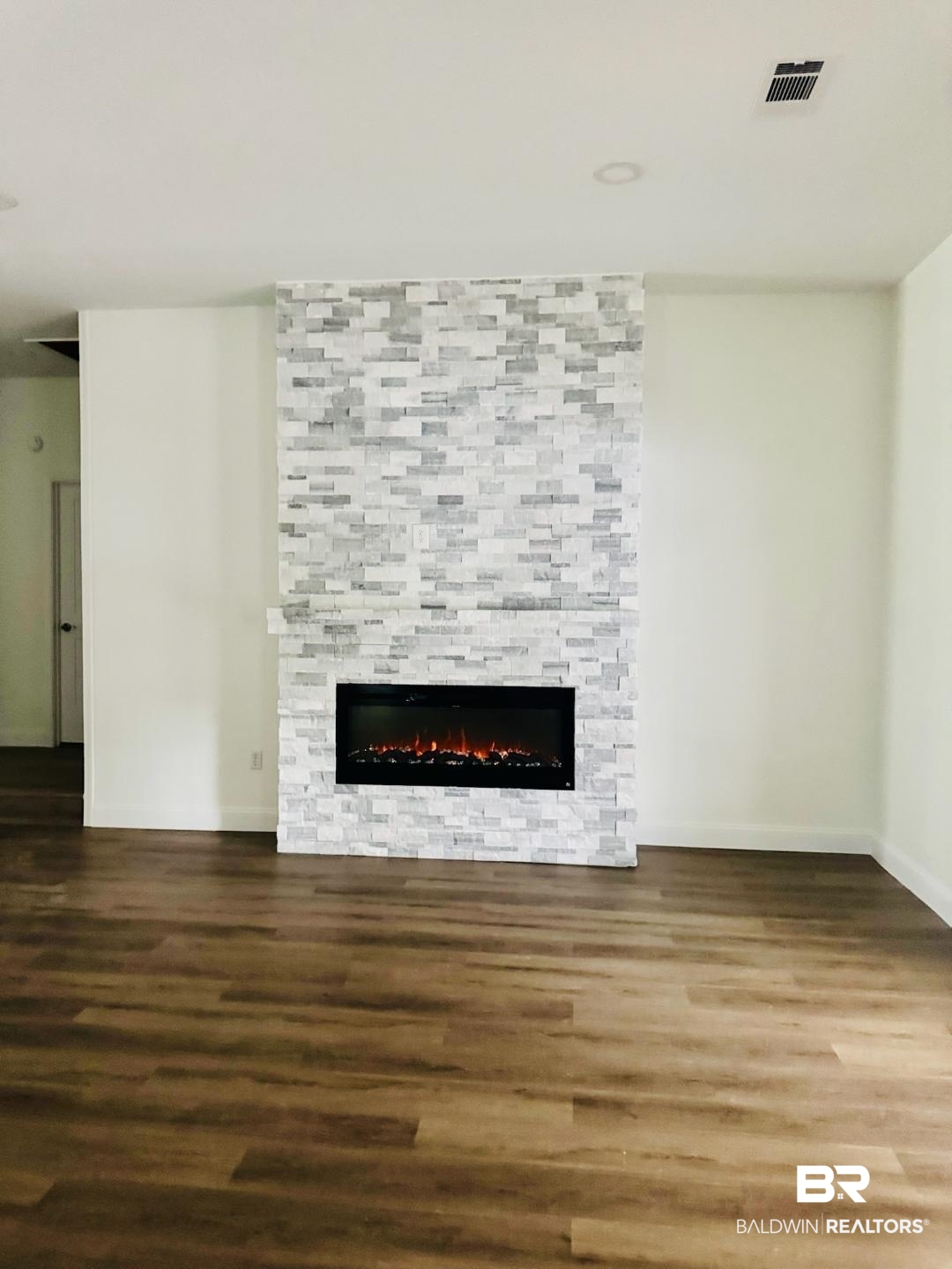 2663 Demetropolis Road Mobile, AL 36693 - Photo 5 of 26 Unfurnished living room with wood finished floors and a fireplace