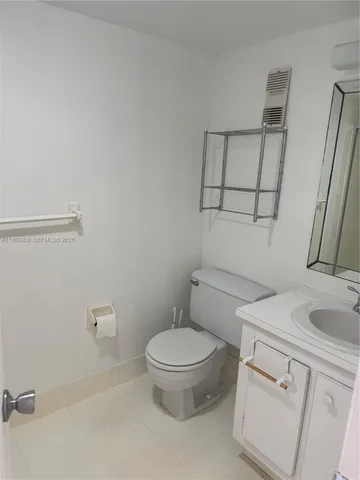 a white toilet sitting next to a bathroom sink