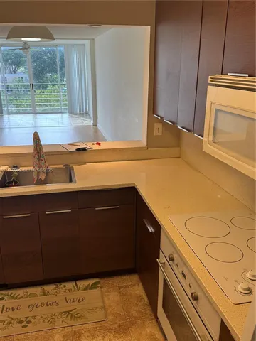 a kitchen with a sink and wooden cabinets