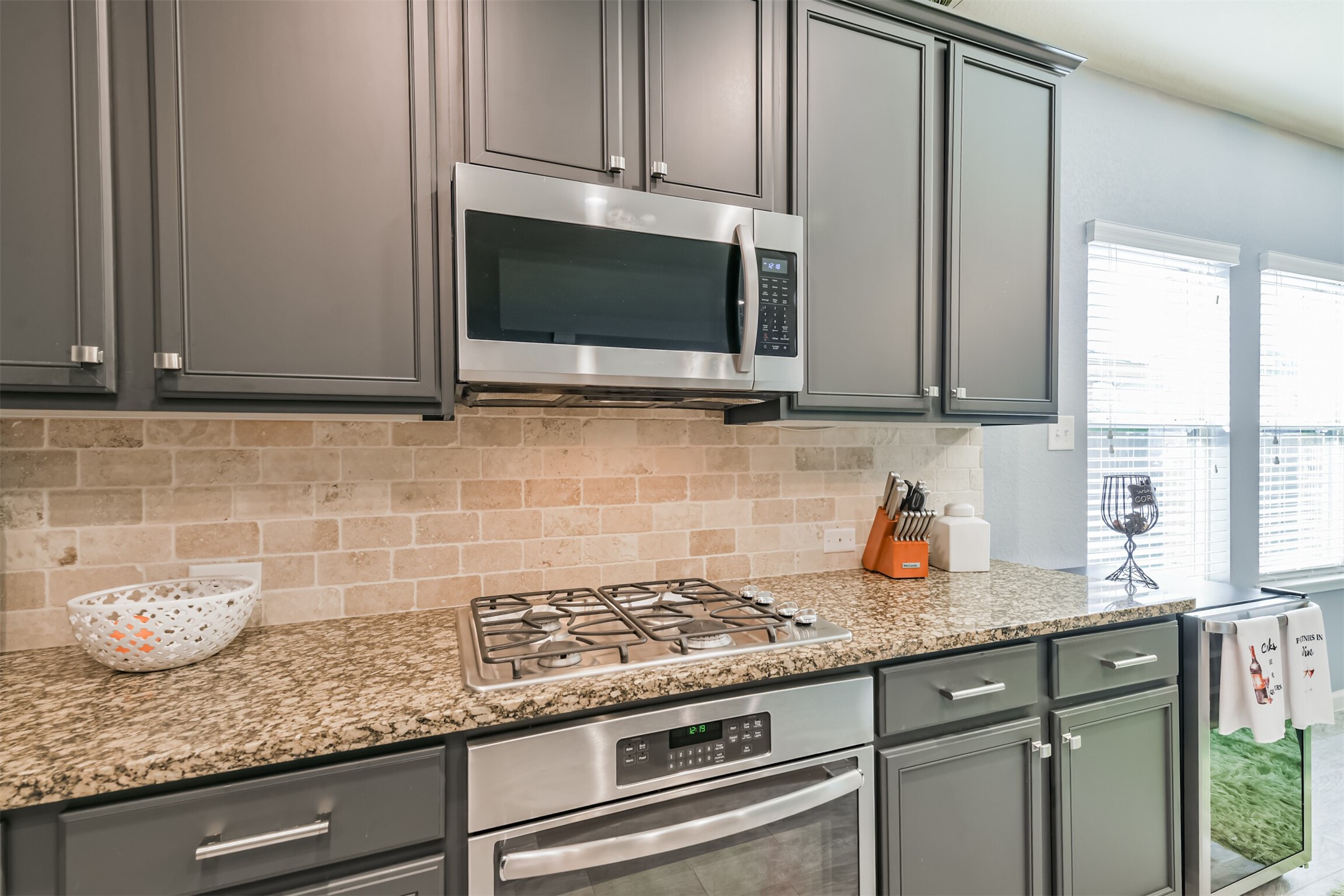 24047 Schults Meadow Lane Spring, TX 77389 - Photo 17 of 47 a kitchen with granite countertop white cabinets stainless steel appliances and a sink