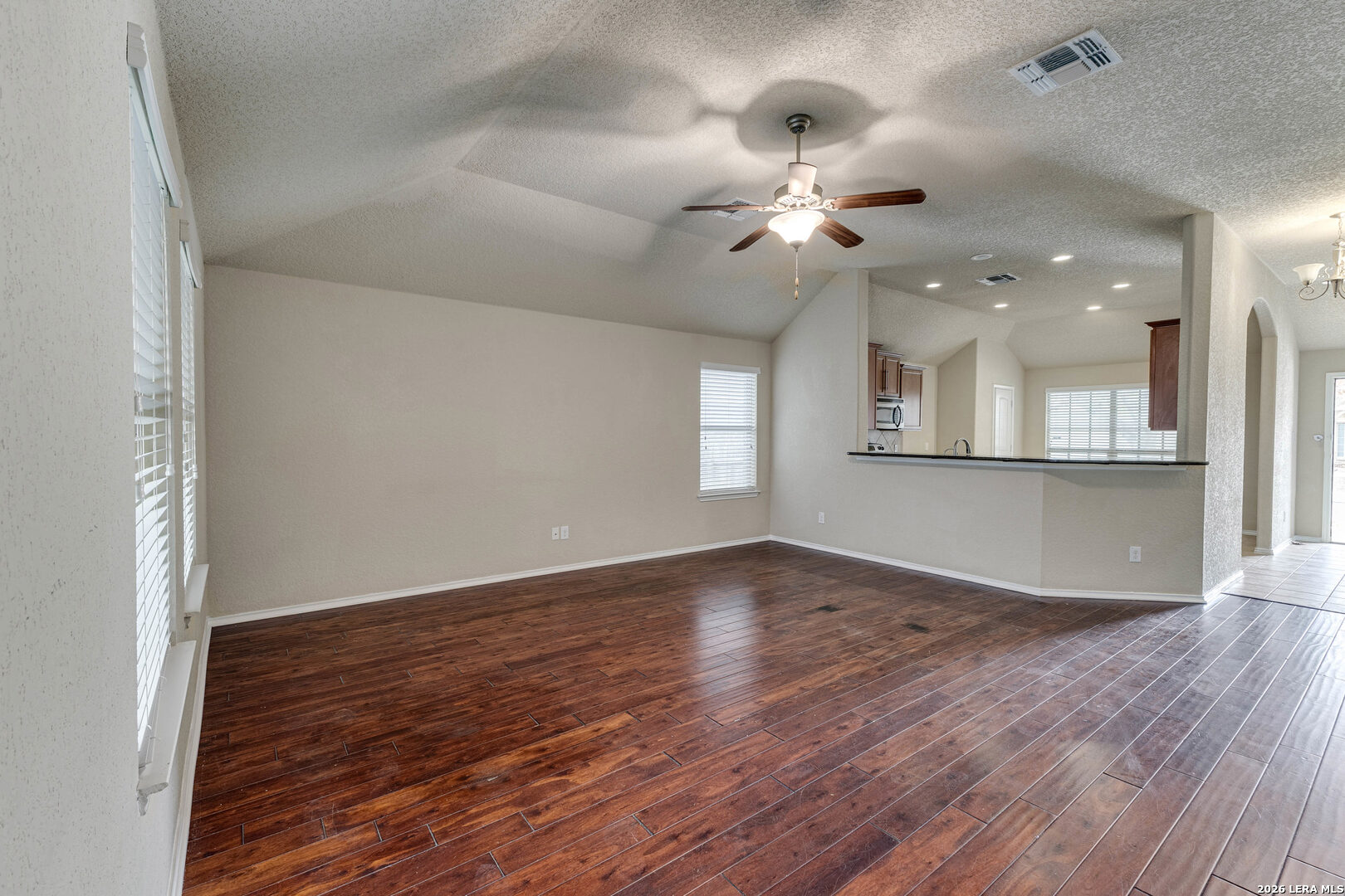 348 Buckboard Lane Cibolo, TX 78108 - Photo 13 of 23 an empty room with wooden floor fan and windows