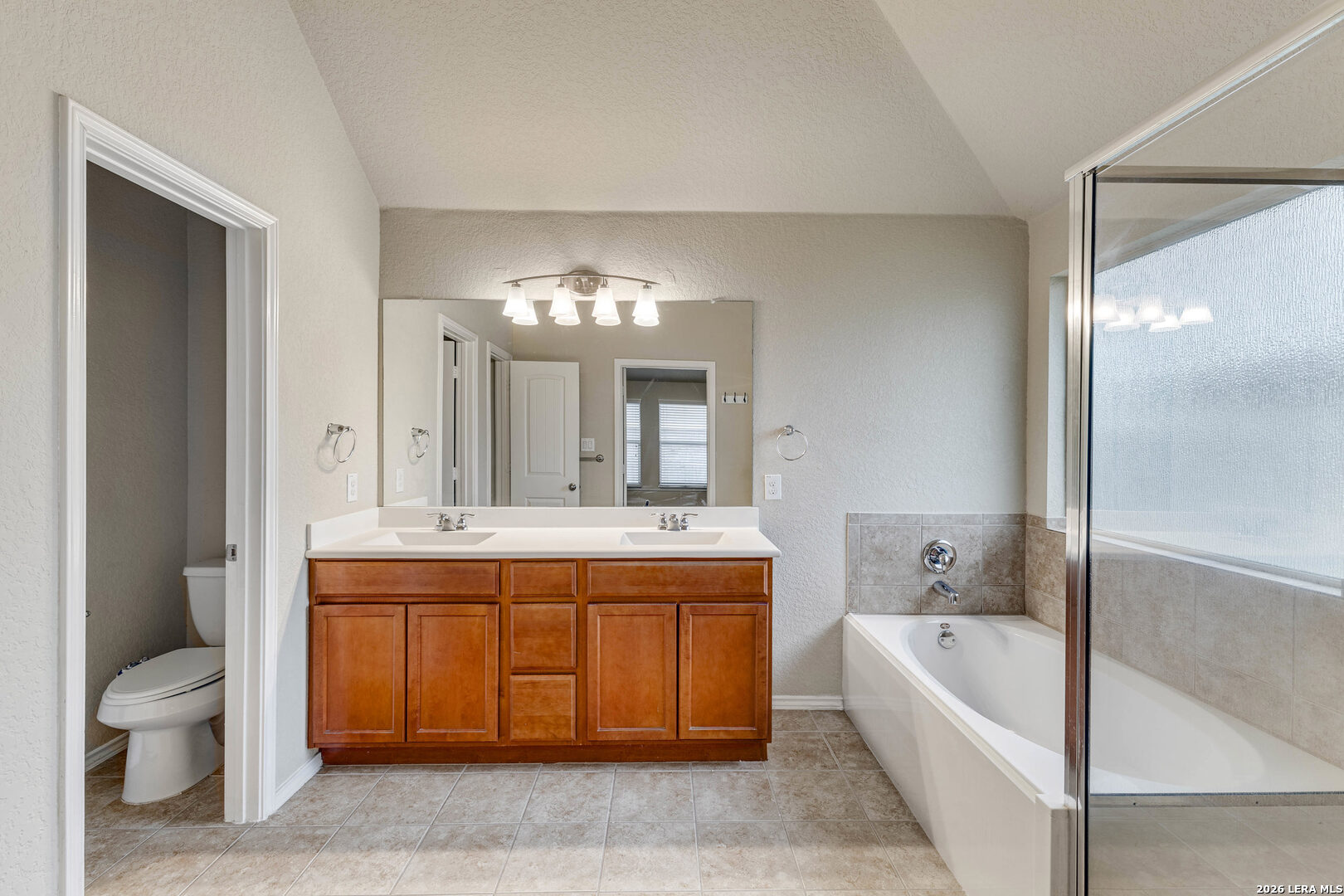 348 Buckboard Lane Cibolo, TX 78108 - Photo 14 of 23 a spacious bathroom with a tub double sink and a mirror