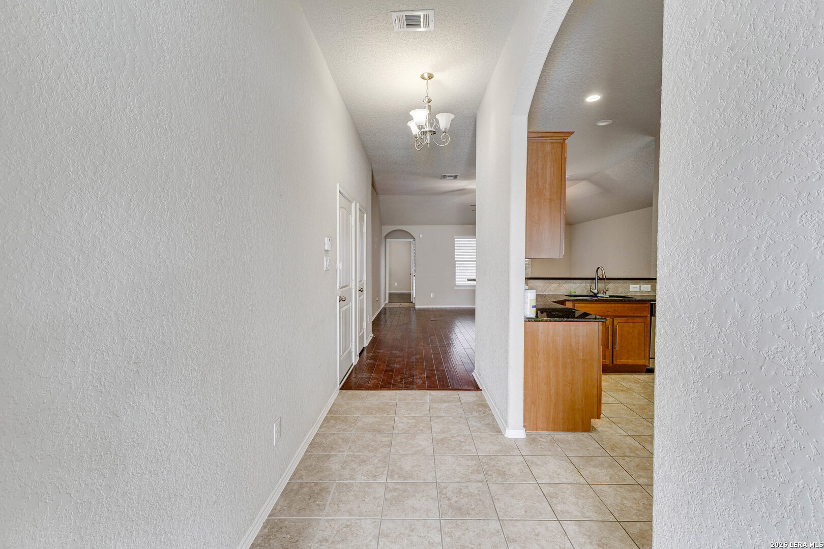 348 Buckboard Lane Cibolo, TX 78108 - Photo 17 of 23 a view of a hallway with wooden floor and a bathroom