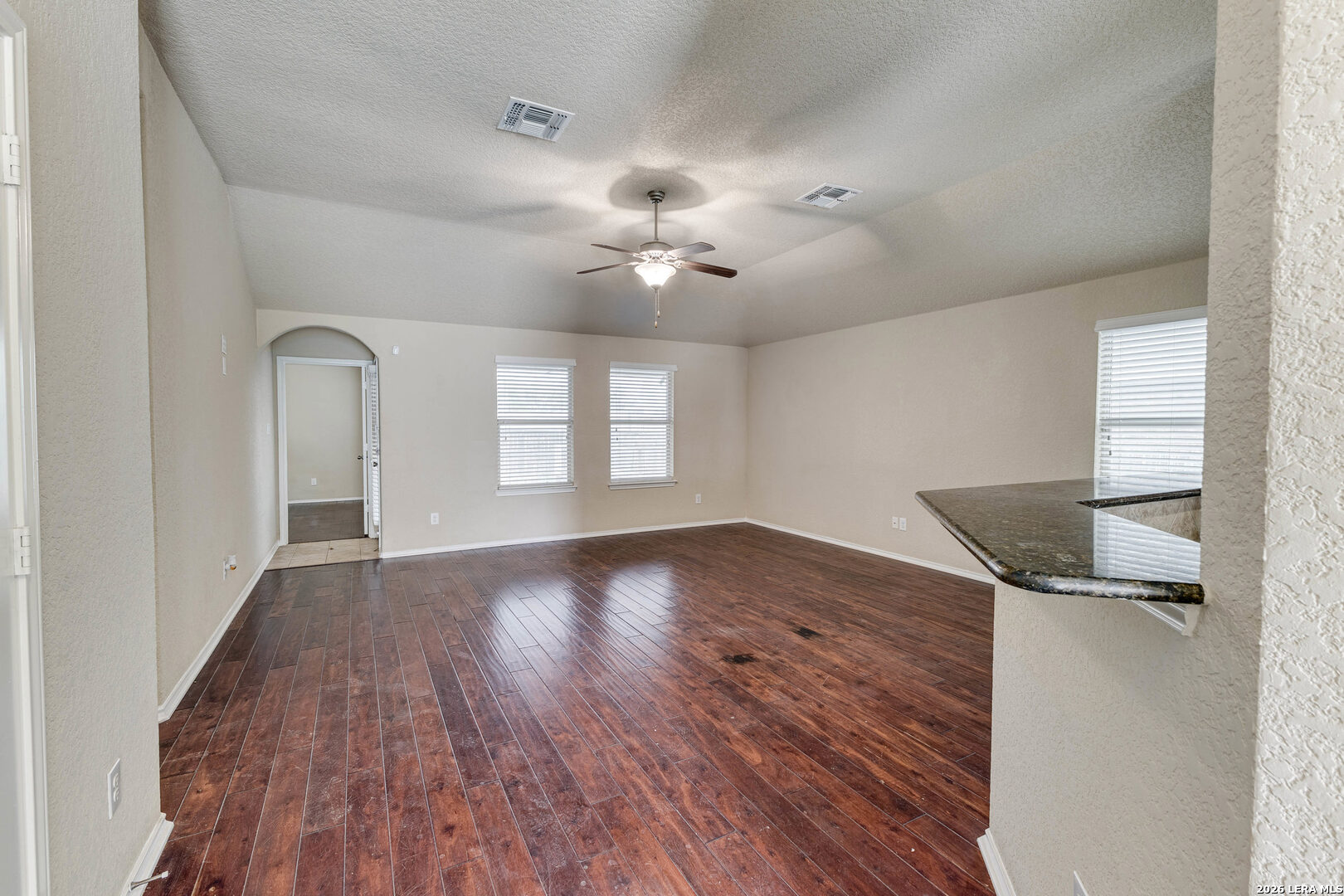 348 Buckboard Lane Cibolo, TX 78108 - Photo 5 of 23 wooden floor in an empty room with a window