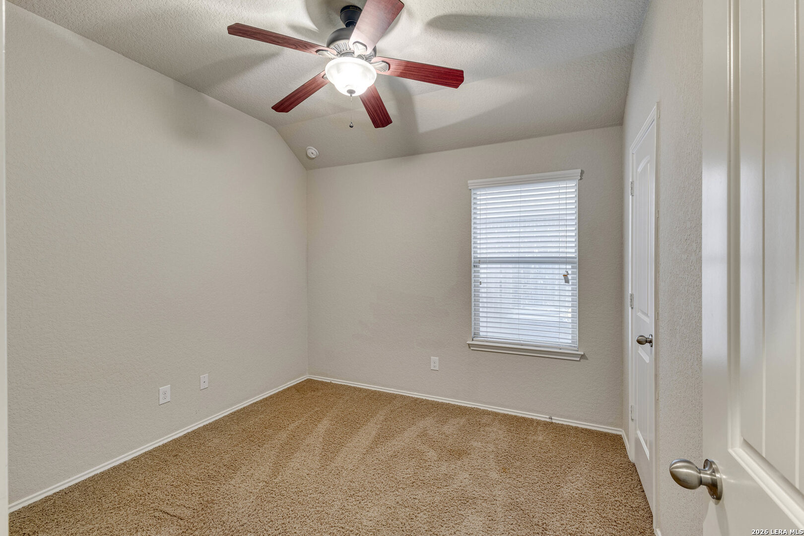 348 Buckboard Lane Cibolo, TX 78108 - Photo 6 of 23 an empty room with a window and a fan