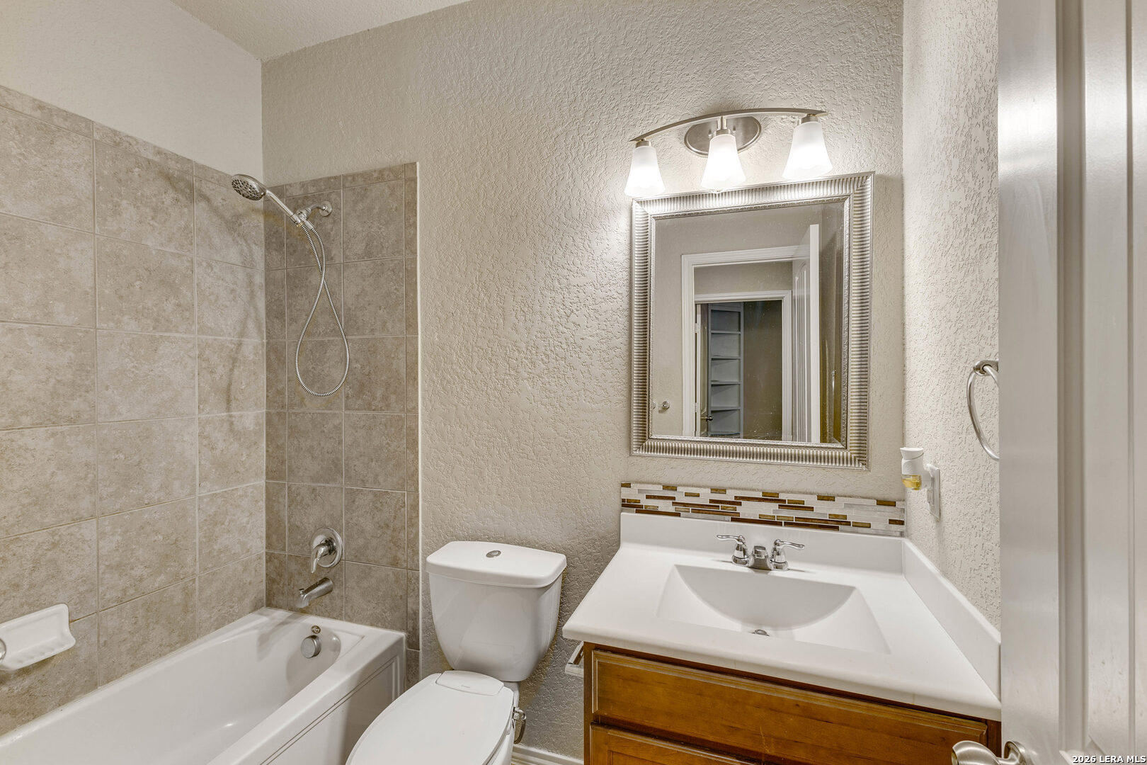 348 Buckboard Lane Cibolo, TX 78108 - Photo 8 of 23 a bathroom with a sink toilet a mirror and shower