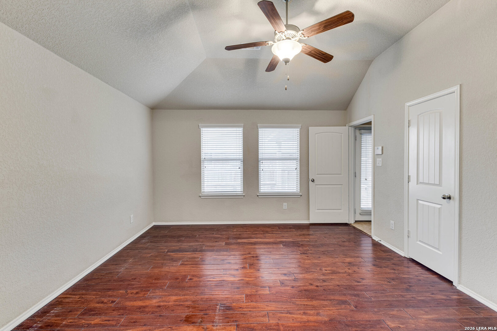 348 Buckboard Lane Cibolo, TX 78108 - Photo 10 of 23 an empty room with wooden floor chandelier fan and windows