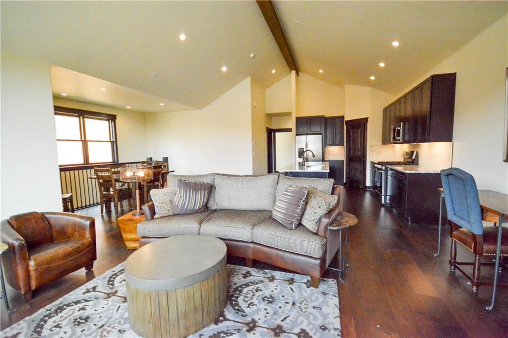 747 Independence Road, Unit 14C Keystone, CO 80435 - Photo 18 of 25 a living room with furniture and a dining table with wooden floor