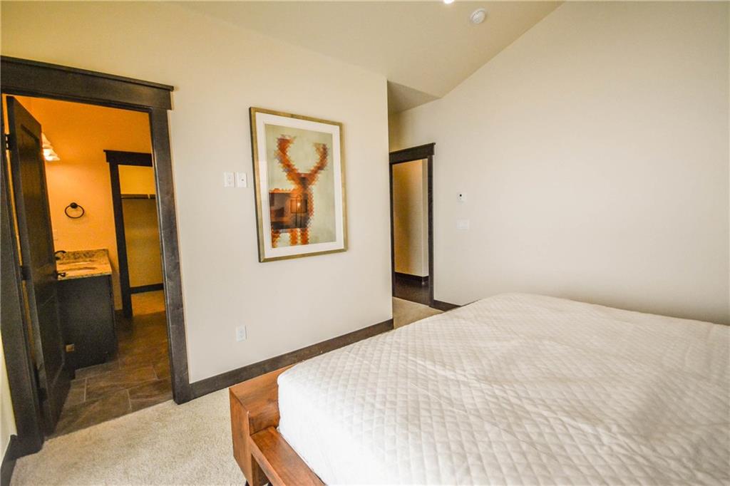 747 Independence Road, Unit 14C Keystone, CO 80435 - Photo 20 of 25 a bedroom with a bed and a dresser next to a window