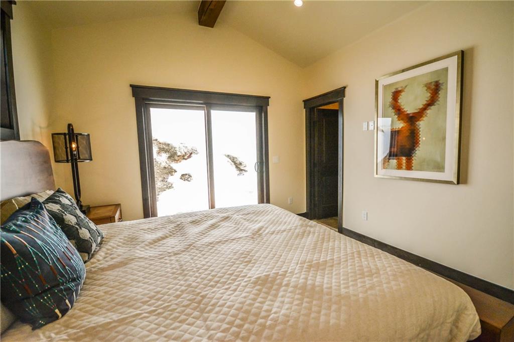747 Independence Road, Unit 14C Keystone, CO 80435 - Photo 21 of 25 a bed sitting in a bedroom next to a window