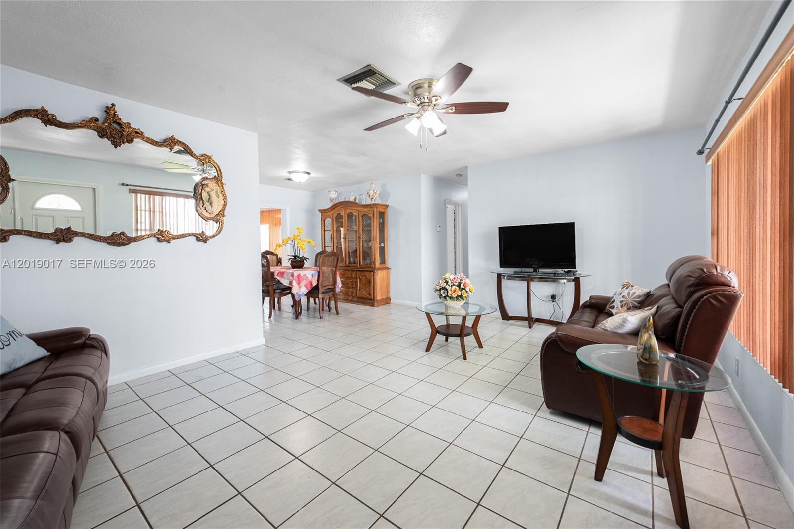 731 Northwest 17th Street Homestead, FL 33030 - Photo 6 of 29 a living room with furniture and a flat screen tv