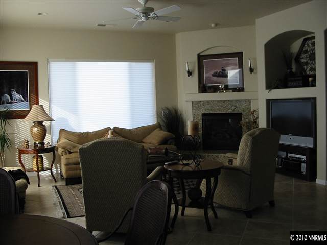 2184 South Tesuque Road Reno, NV 89511 - Photo 2 of 5 a living room with furniture and a fireplace