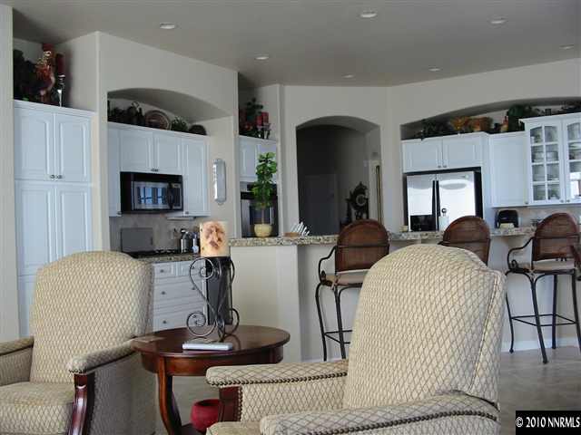 2184 South Tesuque Road Reno, NV 89511 - Photo 3 of 5 a living room with furniture a fireplace and potted plants