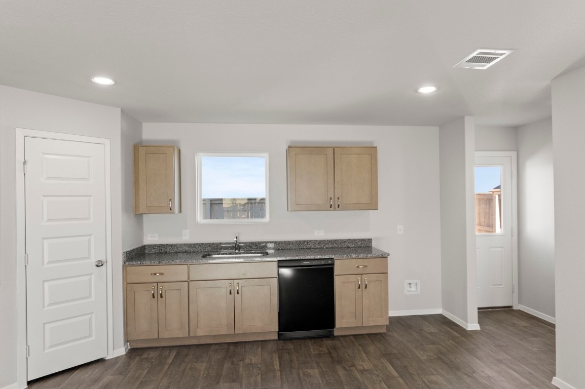 123 Daylily Drive Elgin, TX 78621 - Photo 19 of 33 a kitchen with granite countertop white cabinets and white appliances