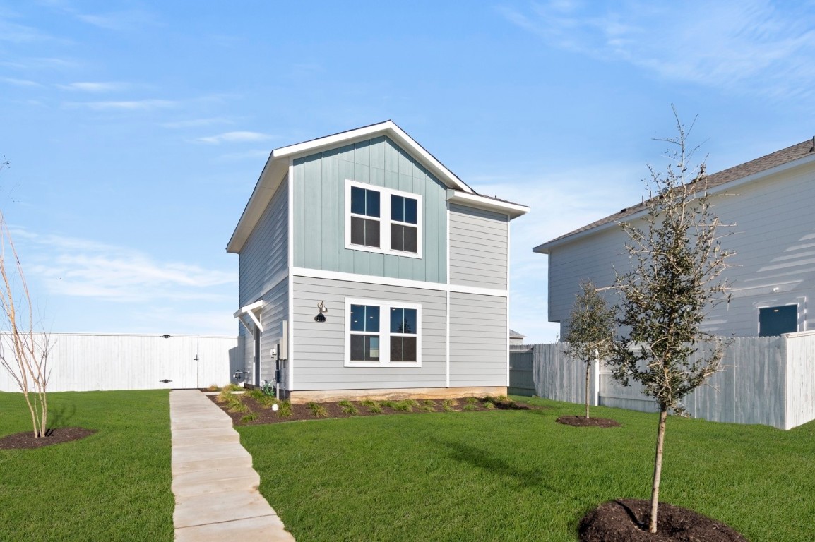 123 Daylily Drive Elgin, TX 78621 - Photo 3 of 33 a front view of a house with a yard